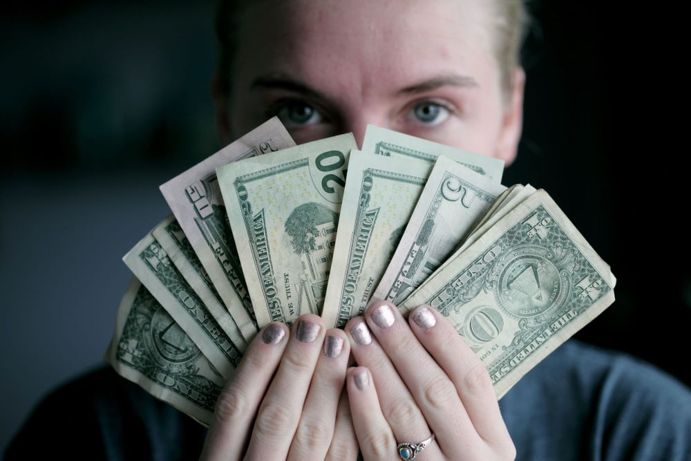 woman holding cash