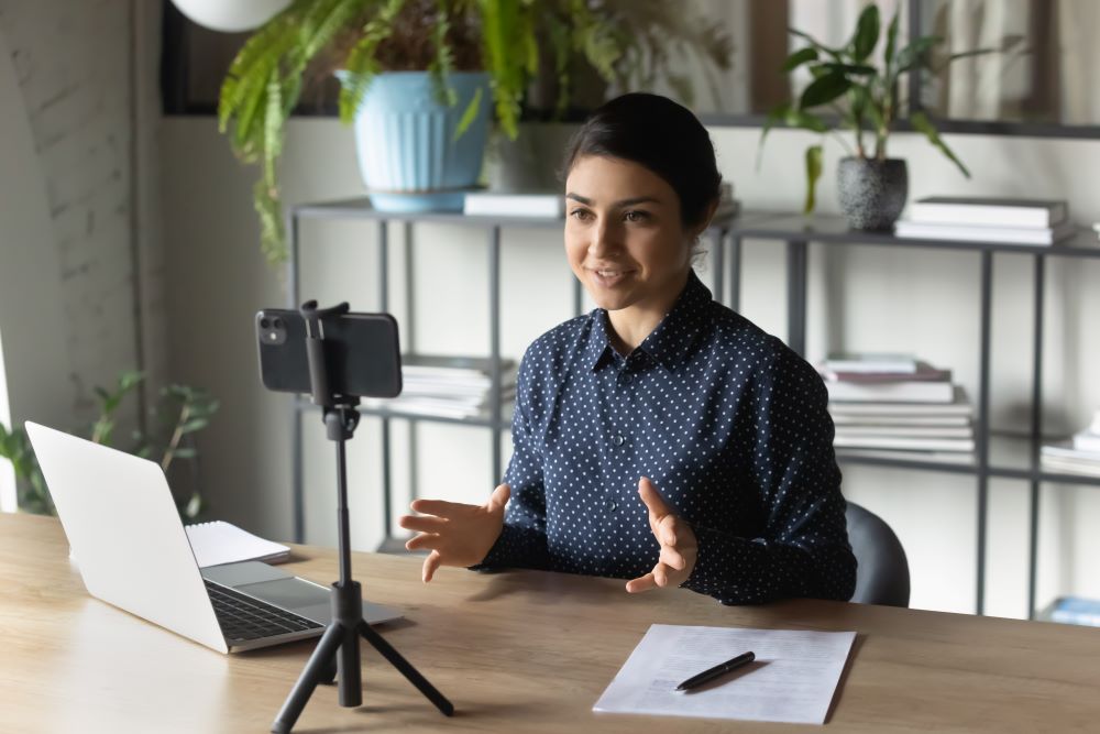 woman recording a class on her phone