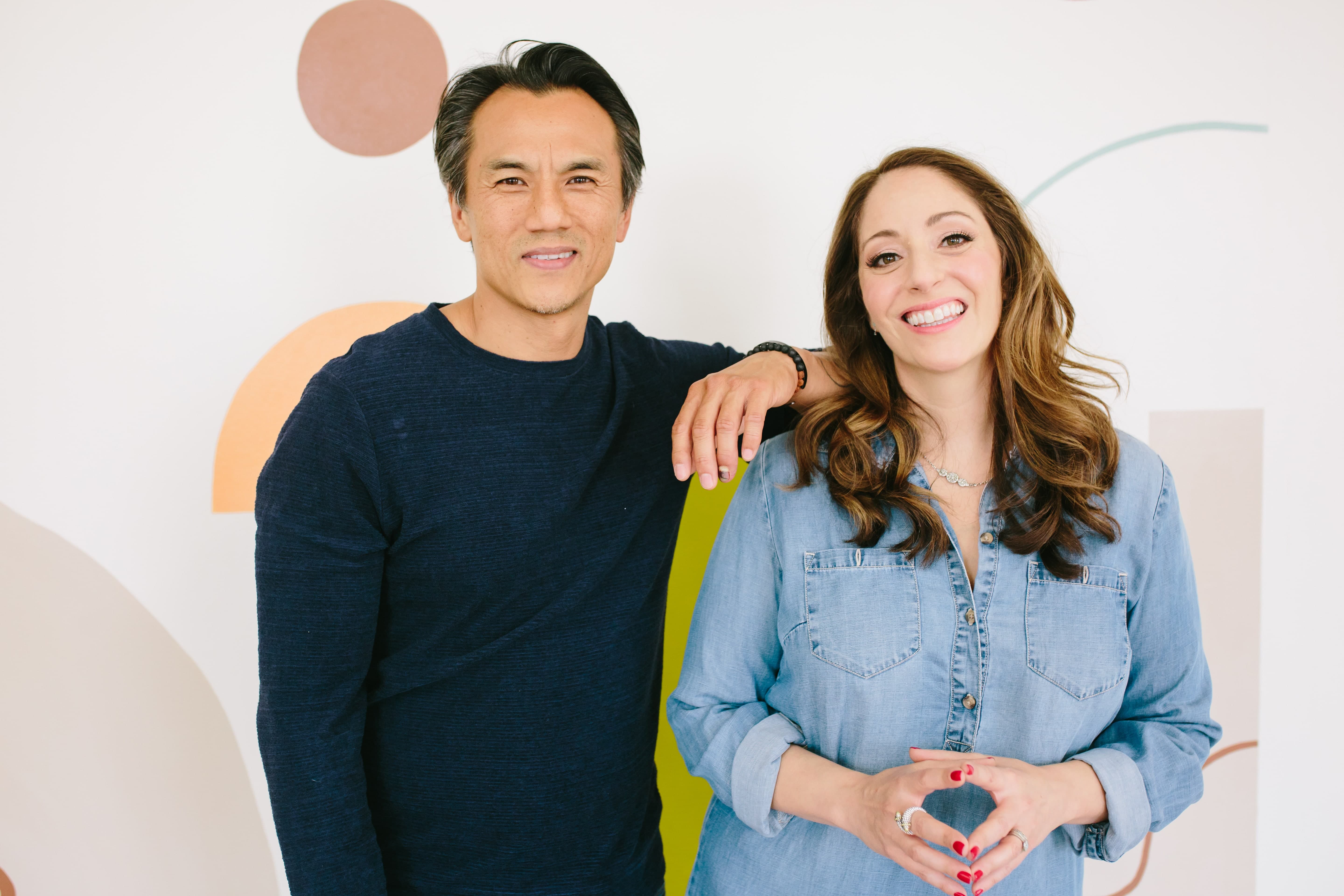 Our best life coach podcasts featuring John Kim and Noelle Cordeaux of Lumia Coaching. Image of John and Noelle standing together and laughing