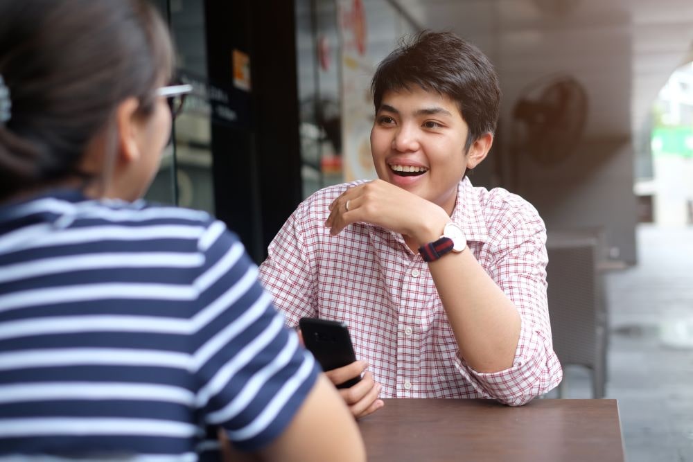 people sitting at a table, talking